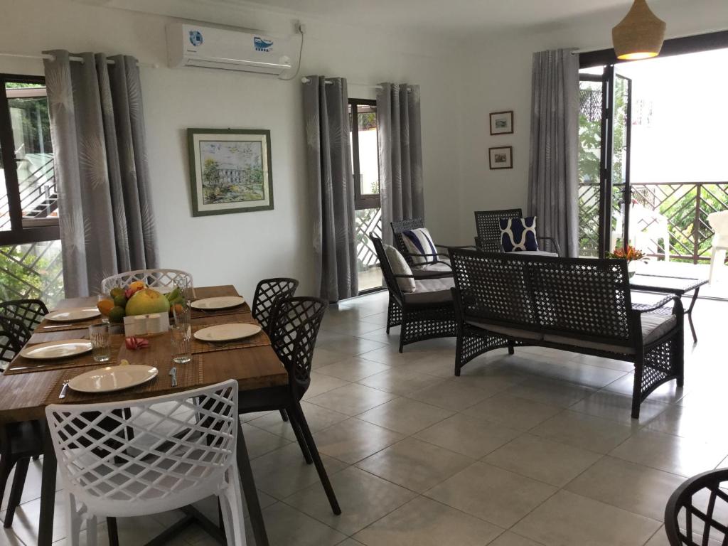 a dining room with a table and chairs at Bougainvillas Seychelles in Anse Royale