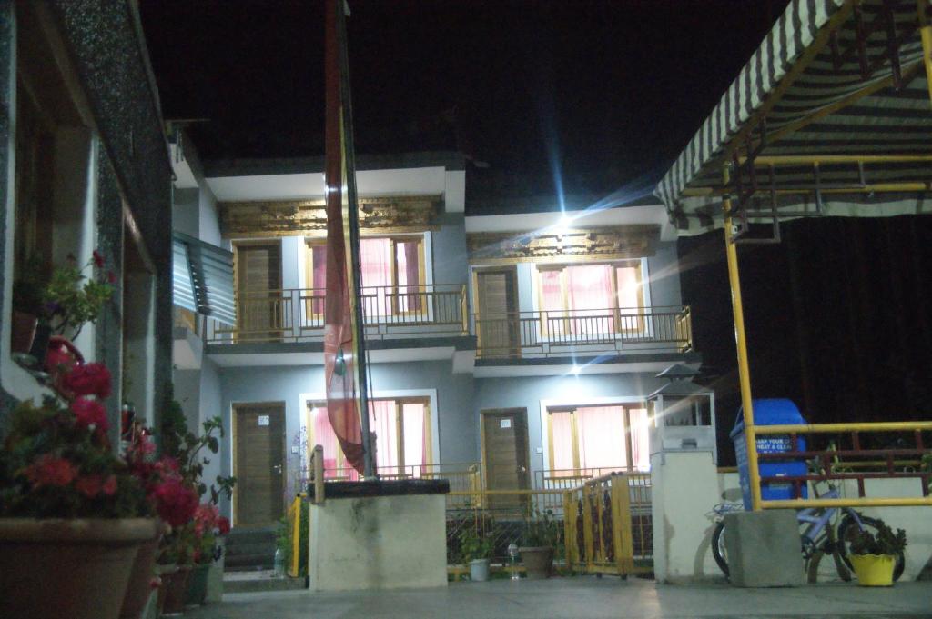 a building with two balconies on the side at night at Chandan Guest House in Leh