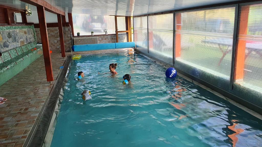 a group of children swimming in a swimming pool at Apartmán U Profesora in Staré Město