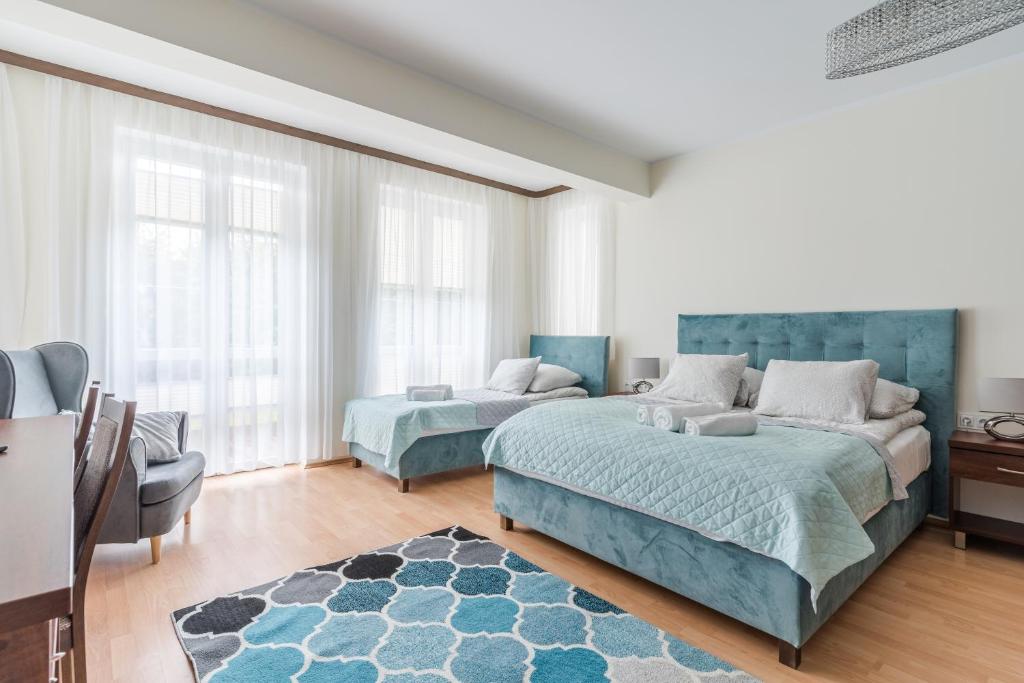 a large bedroom with two beds and a couch at Green House in Ustka