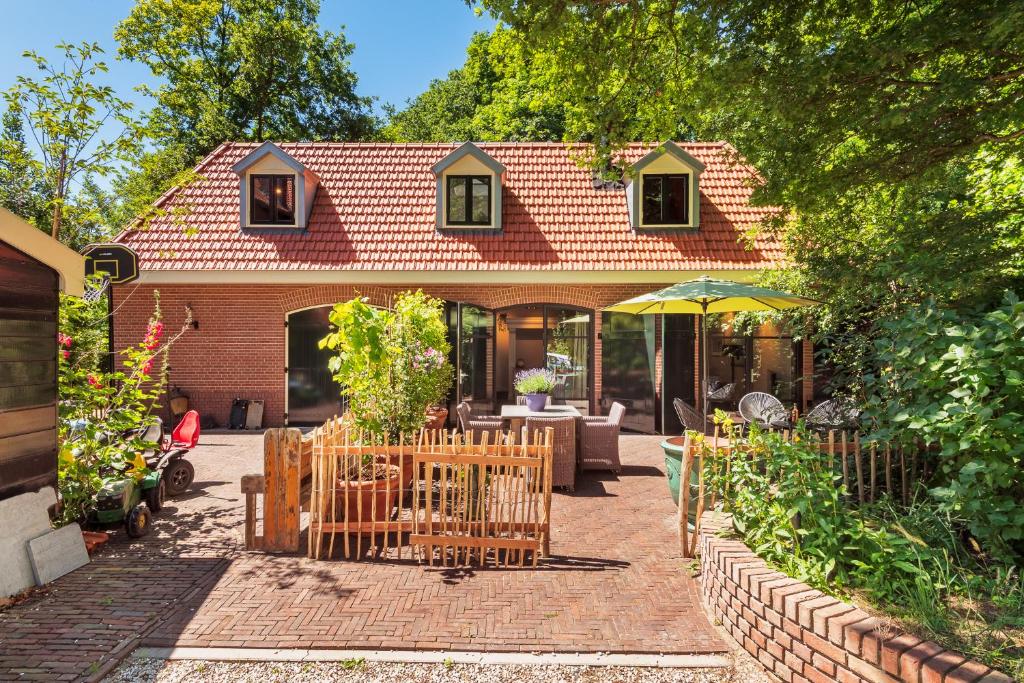a house with a garden and a patio at Bakkum & Beach in Zuidbakkum