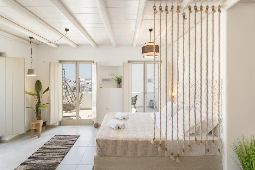 a bedroom with a large bed in a room at Nevma Naousa Boutique Apartment in Naousa
