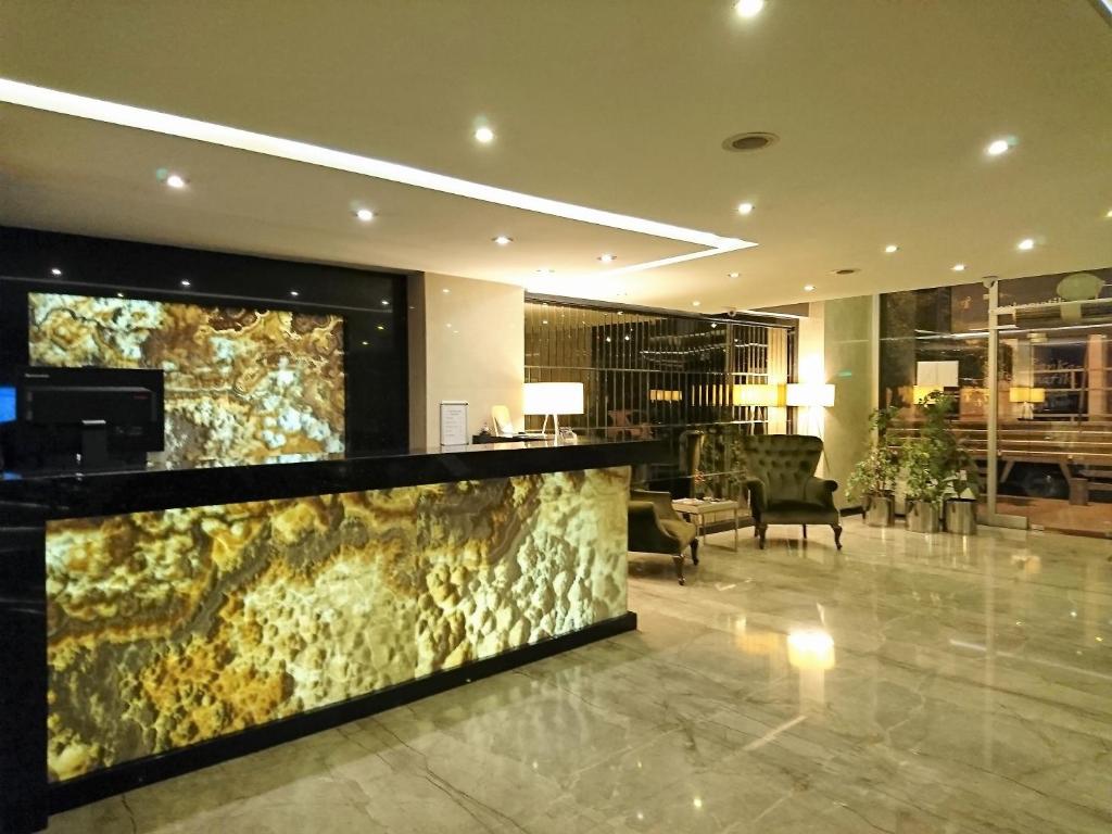 a lobby with a large aquarium in the middle at Laodikya Hotel in Denizli