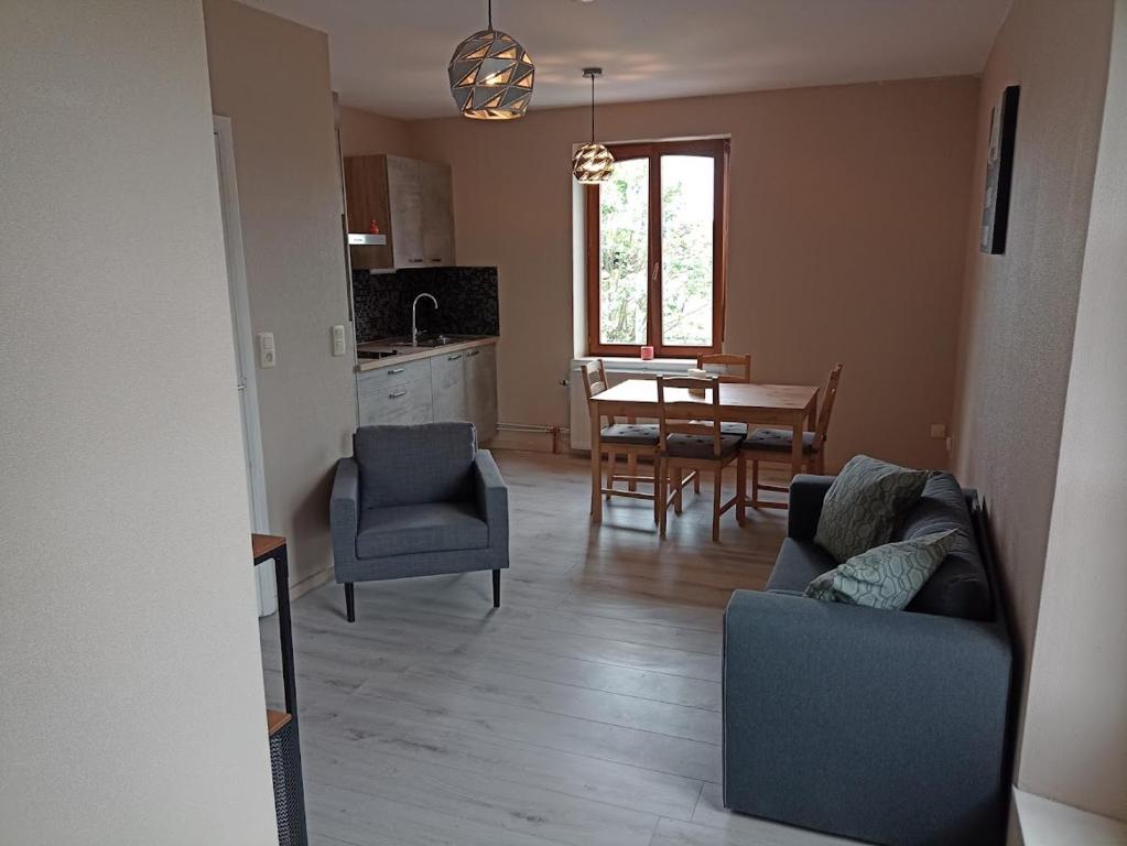 a living room with a couch and chairs and a table at Au Bon pl'Han in Han-sur-Lesse