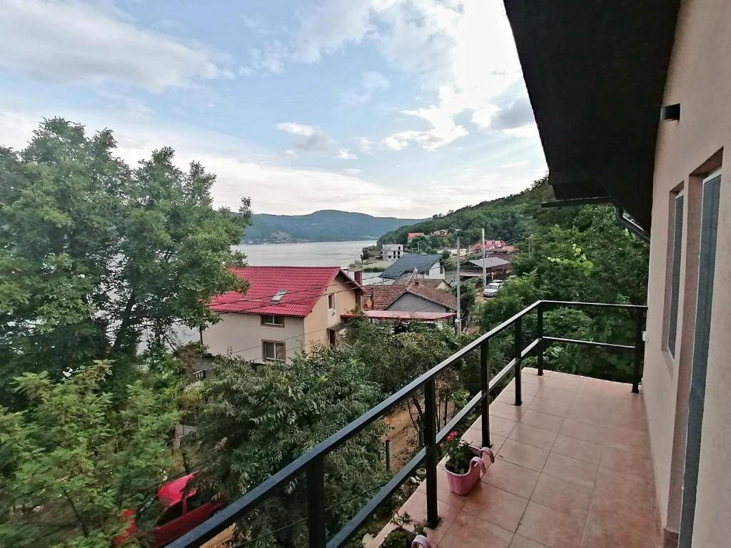 a balcony of a building with a view of the water at Casa Ema in Orşova