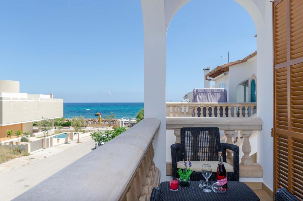 a balcony with a chair and a view of the ocean at YourHouse Ca Na Maria in Son Serra de Marina