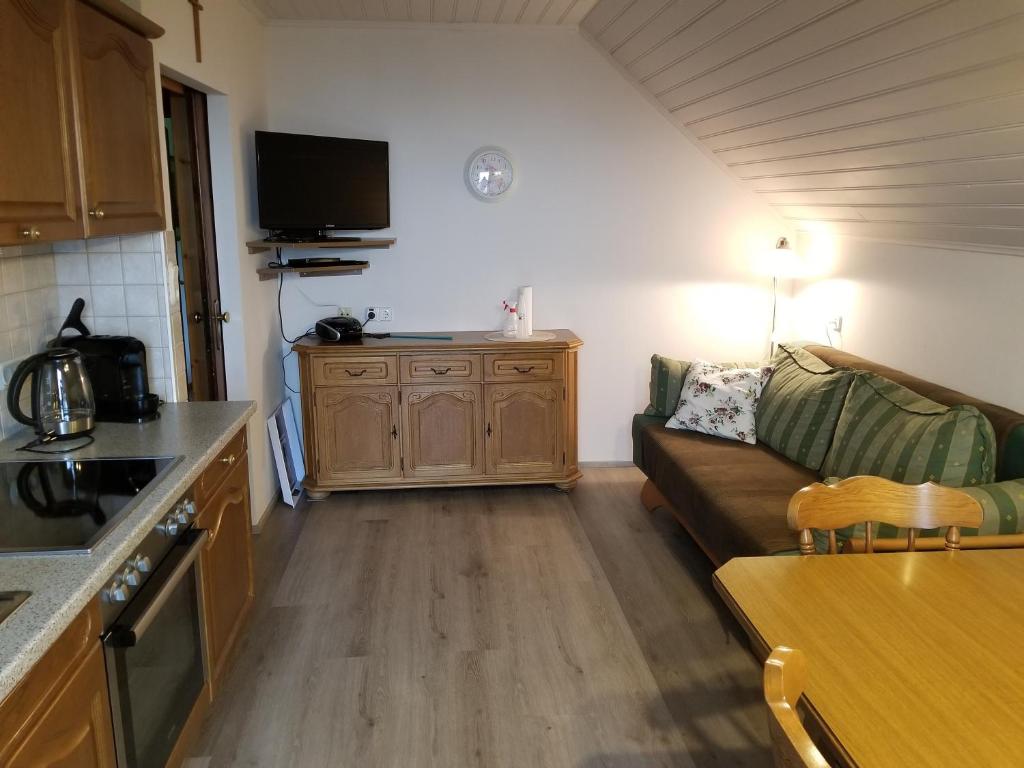 a kitchen and a living room with a couch and a table at Trippolthof in Prebl