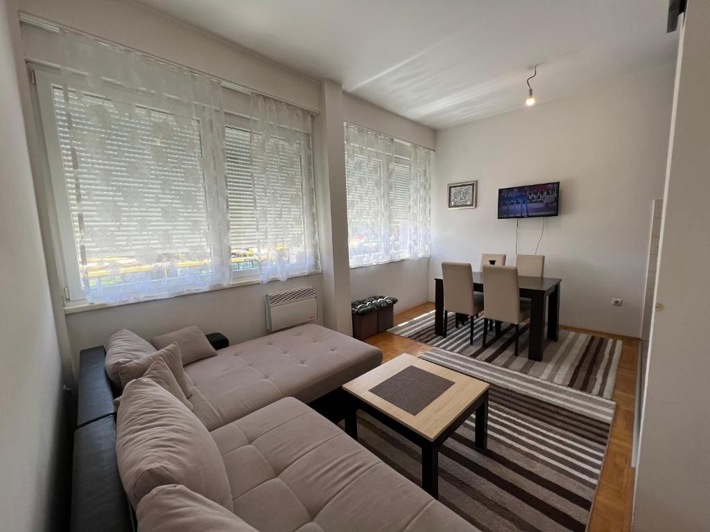 a living room with a couch and a table at Jimmy's Apartment in Sarajevo