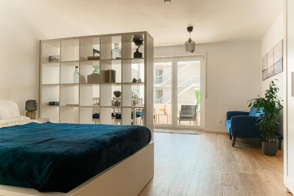 a bedroom with a bed and a large book shelf at Casa d‘Oro in Friedrichshafen