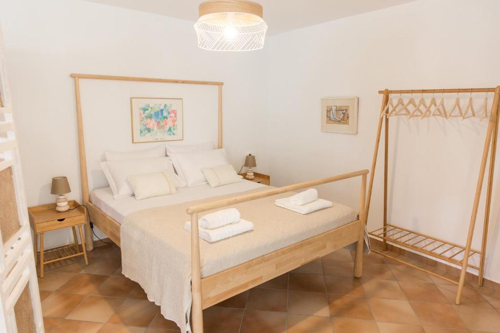 a bedroom with a bed with two towels on it at AZALEA - Modern studio with sea view in Galatas