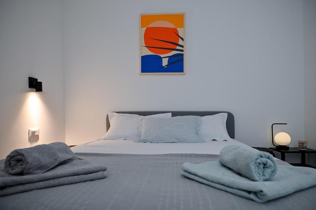 a bedroom with a bed with towels on it at Apartman Festini in Pag