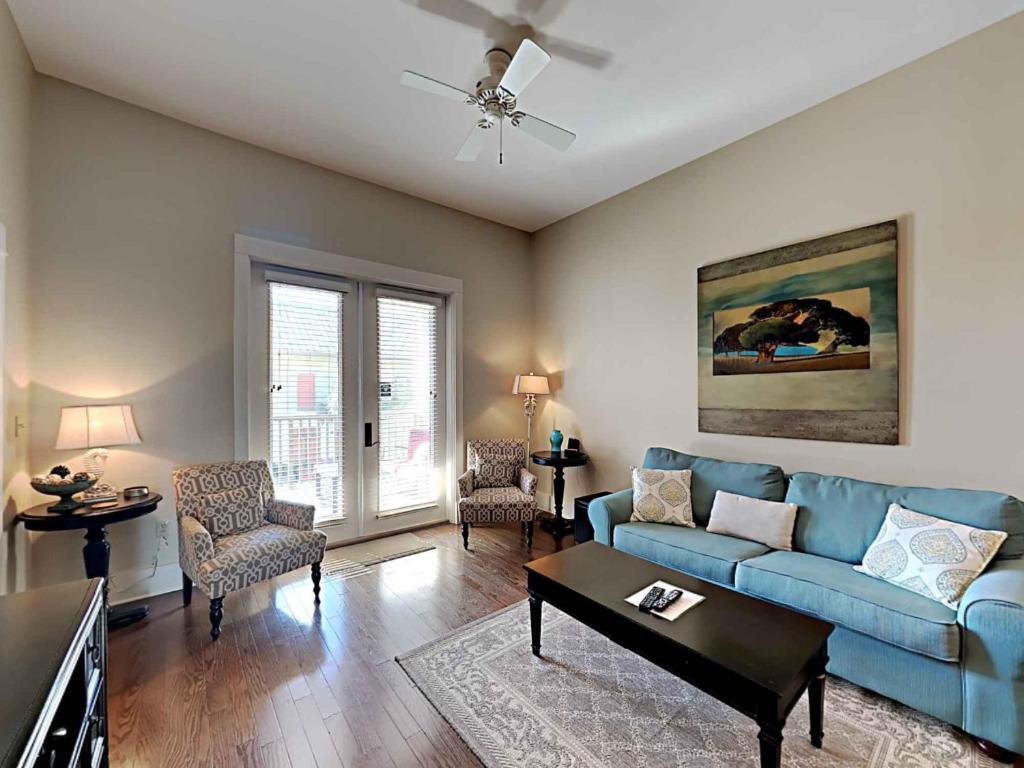 a living room with a blue couch and chairs at Redfish Village m1-218 in Blue Mountain Beach