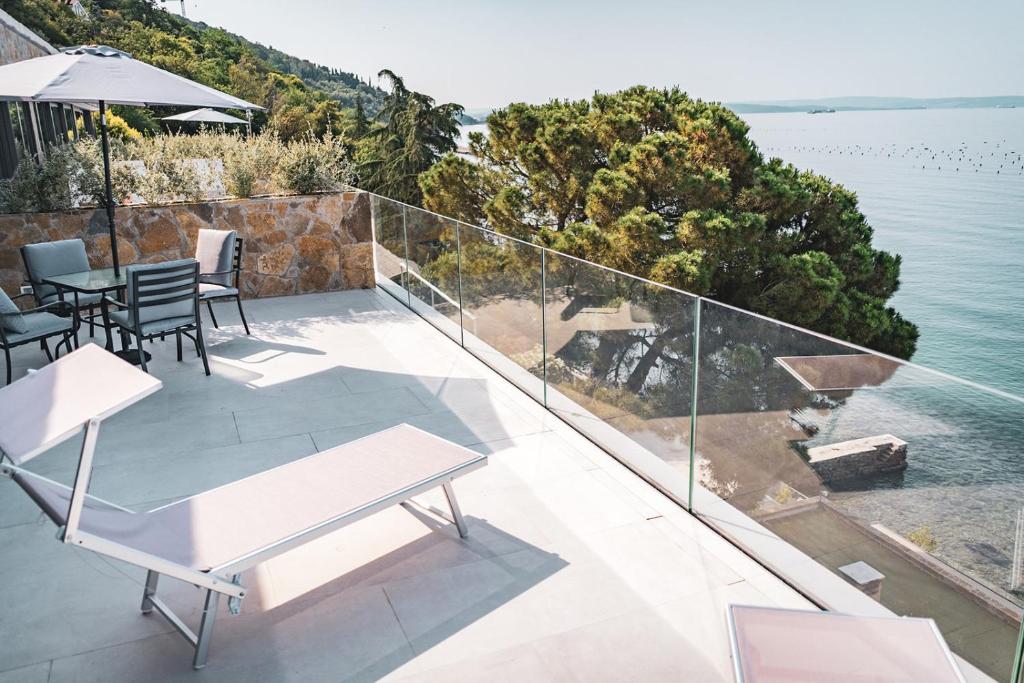 a balcony with a view of the water at Seaside Resort in Trieste