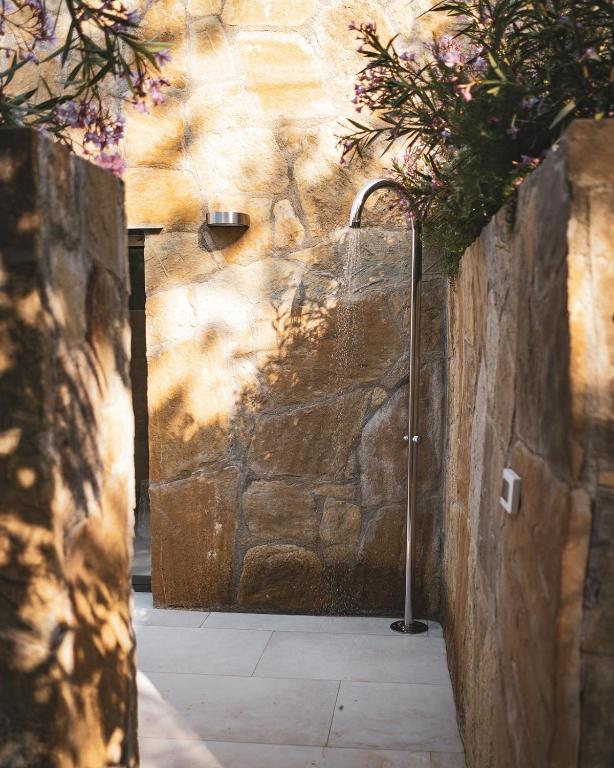 an entrance to a stone wall with flowers on it at Seaside Resort in Trieste
