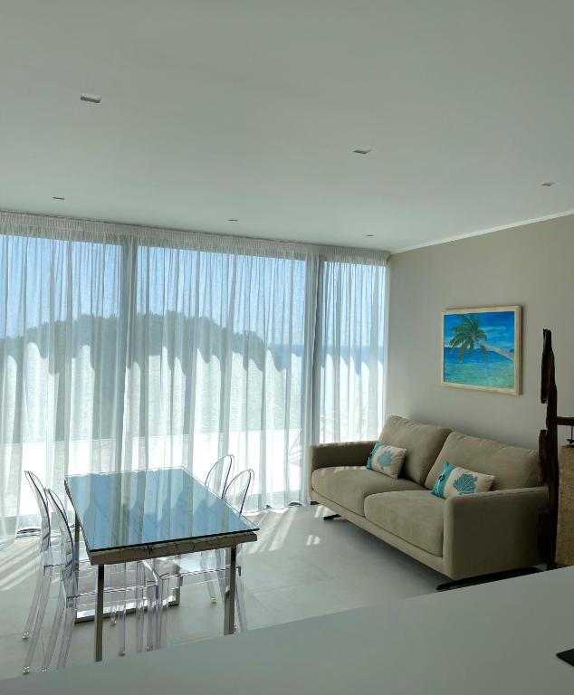 a living room with a couch and a glass table at Seaside Resort in Trieste