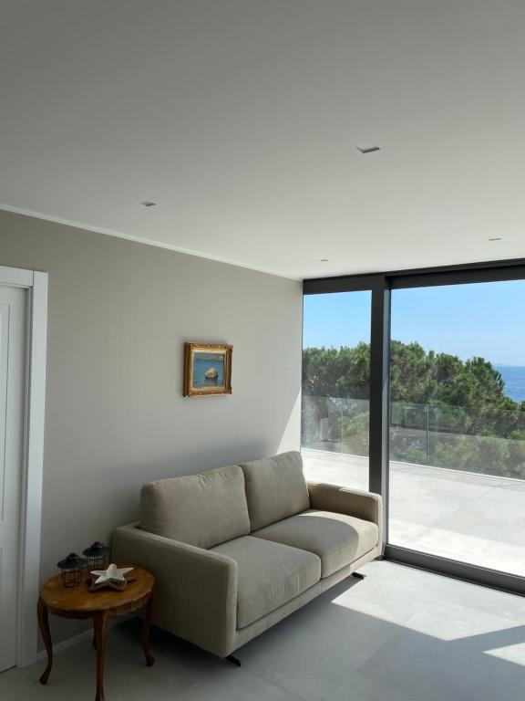 a living room with a couch and a large window at Seaside Resort in Trieste