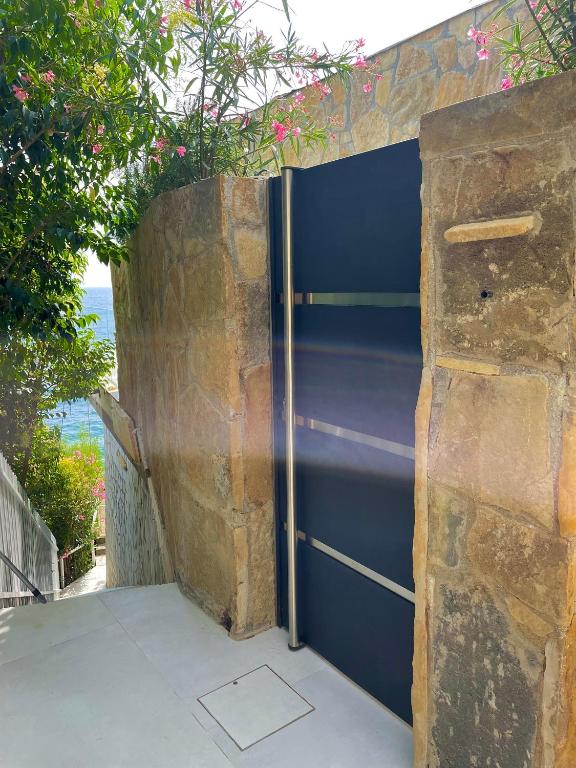 a metal refrigerator sitting next to a stone wall at Seaside Resort in Trieste