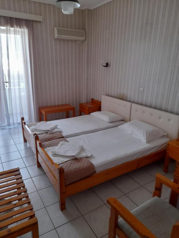 Postel nebo postele na pokoji v ubytování Phaethon Hotel