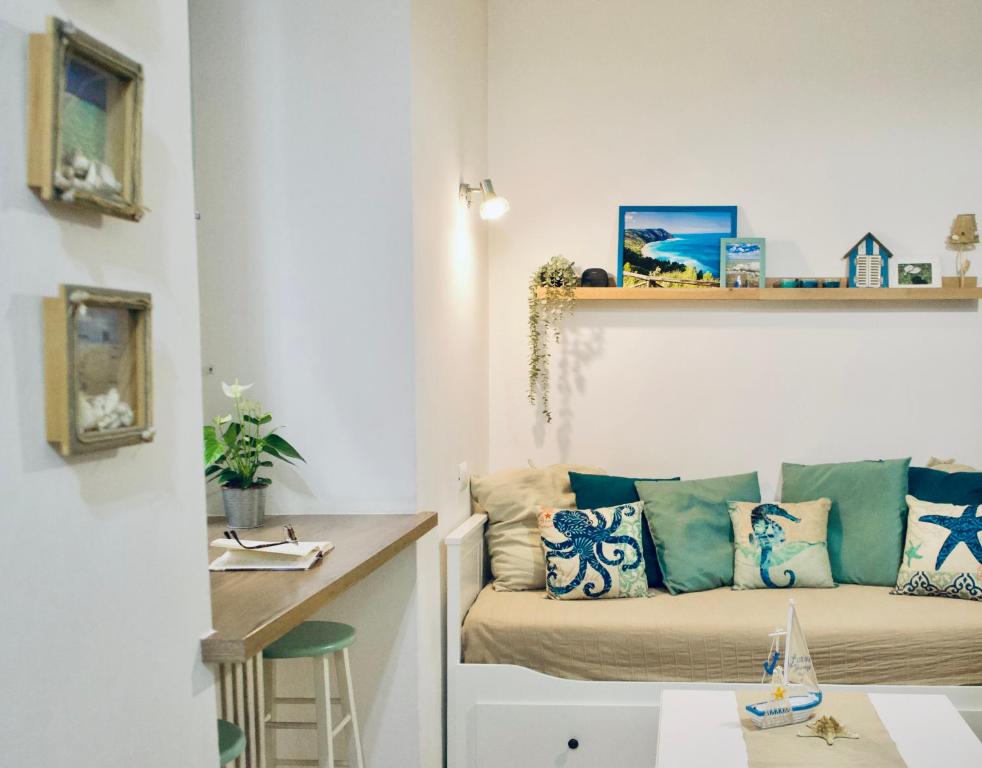 a living room with a couch and a table at Il Mono del Porto - Studio Apartment in Ancona