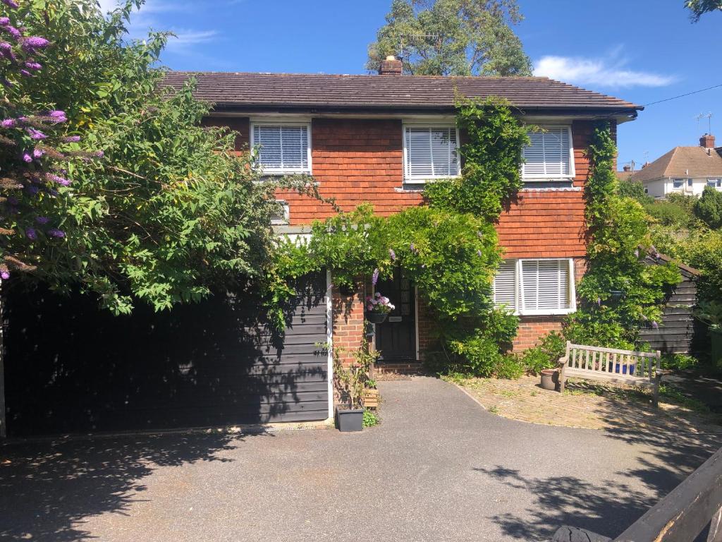 a brick house with ivy growing on it at Lewes Beautiful sunny flat in the historic town in Lewes