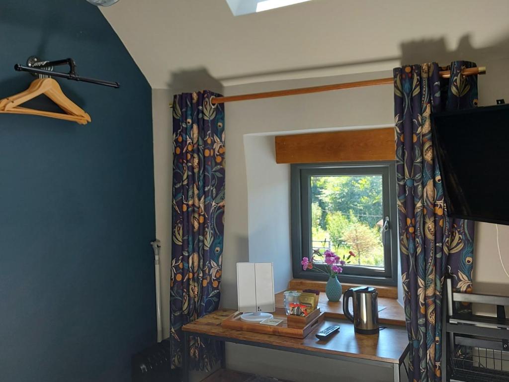 a room with a desk and a window at Longstone Bed & Breakfast in Challacombe