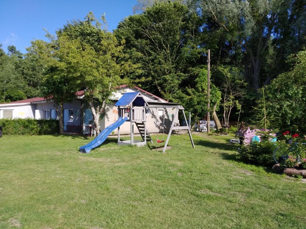 a playground with a slide in a yard at KEJA Pustkowo in Pustkowo