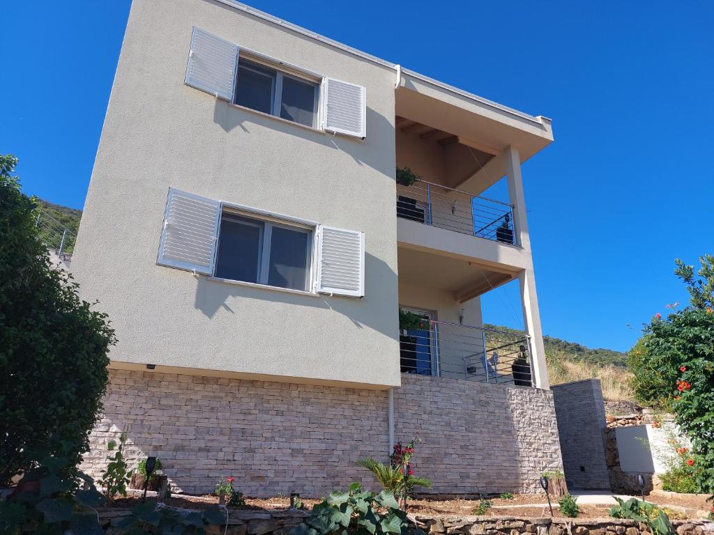 a building with white shutters on it at HOLIDAY HOME KATE in Vis