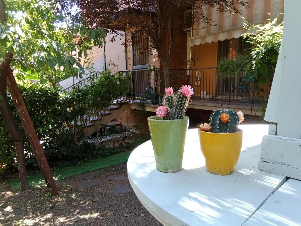 three vases sitting on a table in front of a house at A CASA DI GEMMA in Bologna