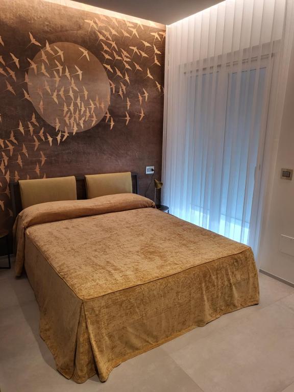 a bedroom with a bed with a painting on the wall at Casa Stazione Pescara in Pescara