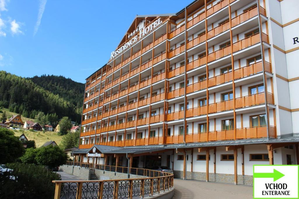 a hotel building with a bridge in front of it at Apartman MARLEA in Donovaly