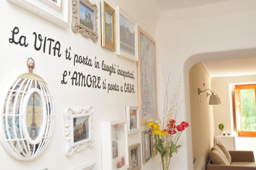 a living room with pictures on the wall at Come a casa in Cava deʼ Tirreni