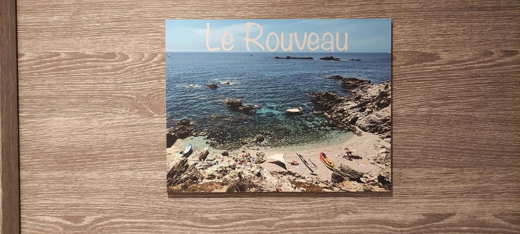 a book with a picture of a beach at Le Rouveau in Six-Fours-les-Plages