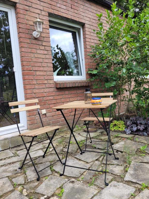 - une table de pique-nique et 2 chaises devant un bâtiment dans l'établissement Ferienwohnung Sonnenschein, à Obernkirchen