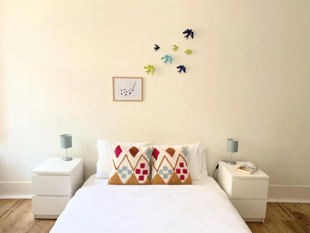 a bedroom with a bed with two night stands and two lamps at Portuguese apartment in the heart of Lisbon in Lisbon