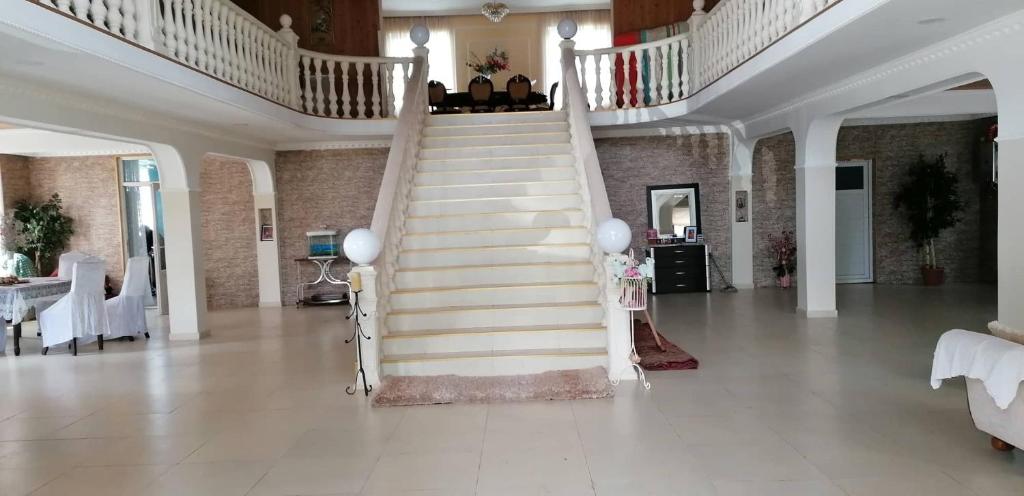 a staircase in a living room with a stair case at Special Guest House in Guria in Chala