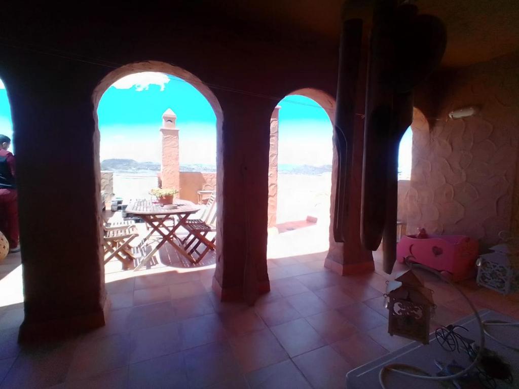 a room with arched windows and a view of the city at Apartamento Mojacar Playa in Mojácar