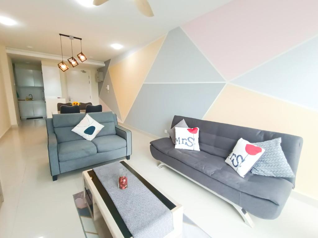 a living room with two couches and a table at Medini Signature x 3min to Legoland x 2BR x 7pax in Nusajaya