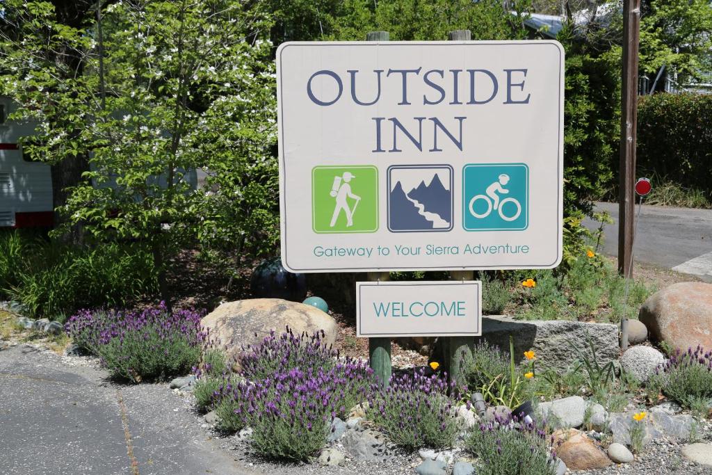 a sign for a outside inn in a garden at Outside Inn in Nevada City