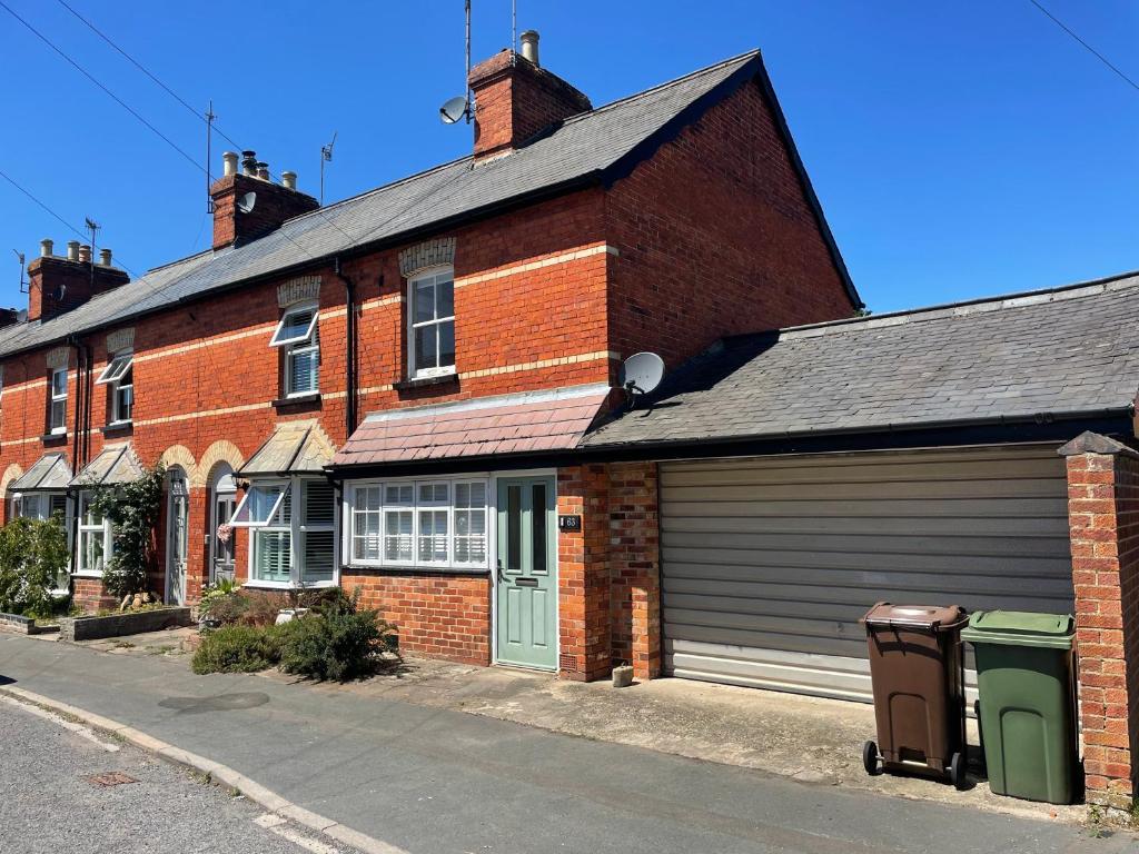 a brick building with a garage on a street at Park End House - Parking, Pet Friendly in Henley on Thames
