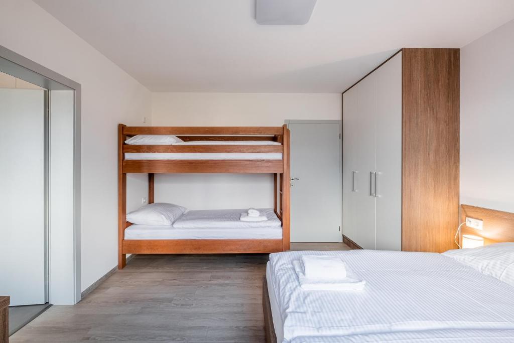 Postel nebo postele na pokoji v ubytování Apartmány ZaBukem