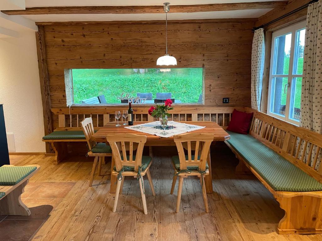 a dining room with a wooden table and chairs at Landhaus Waisenegg 
