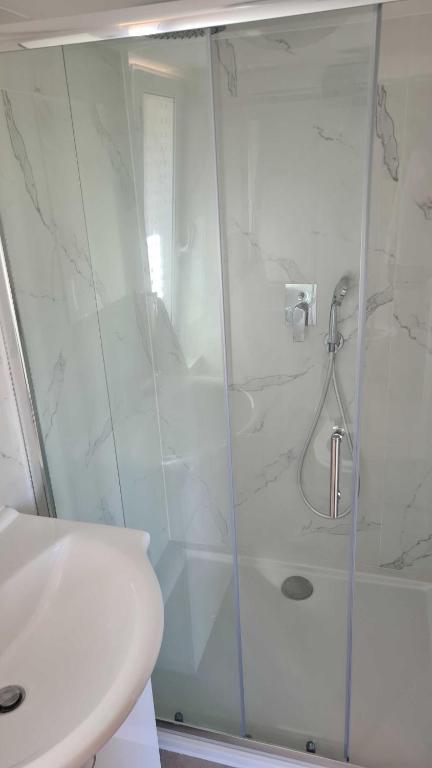 a bathroom with a shower with a glass door at Orlická přehrada Chata Malá in Kožlí u Orlíka