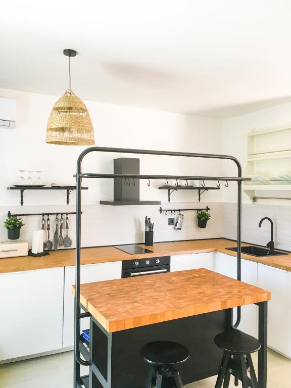 a kitchen with a table and two bar stools at Land and Sea in Primošten