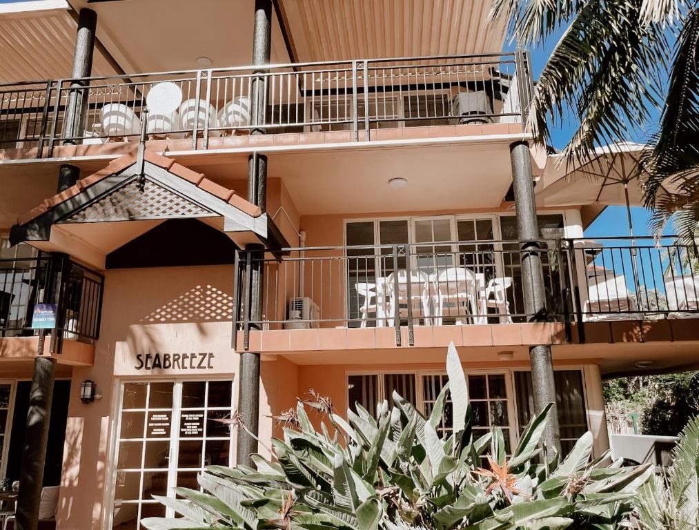 a building with a balcony with a cow on it at Sea Breeze on Main Beach in Byron Bay