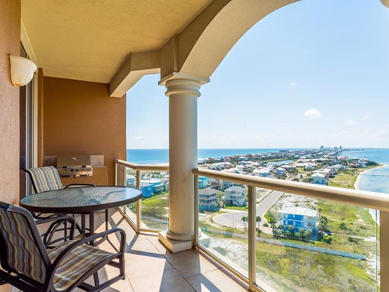 a balcony with a table and chairs and the ocean at Portofino Island Resort #4-1309 in Pensacola Beach