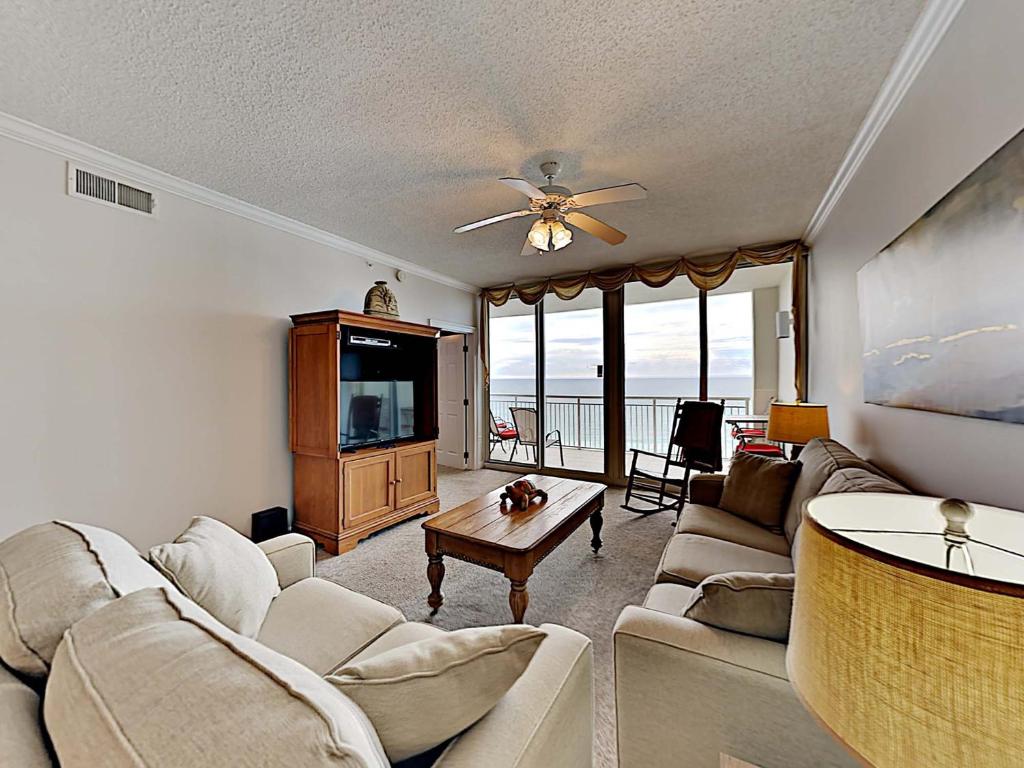 a living room with a couch and a tv at The Pearl of Navarre #805 in Navarre