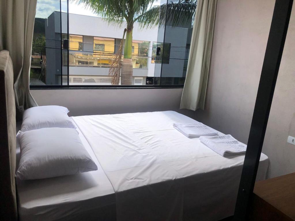 a bed in a room with a window at Canastra Flat Hospedagem in Vargem Bonita