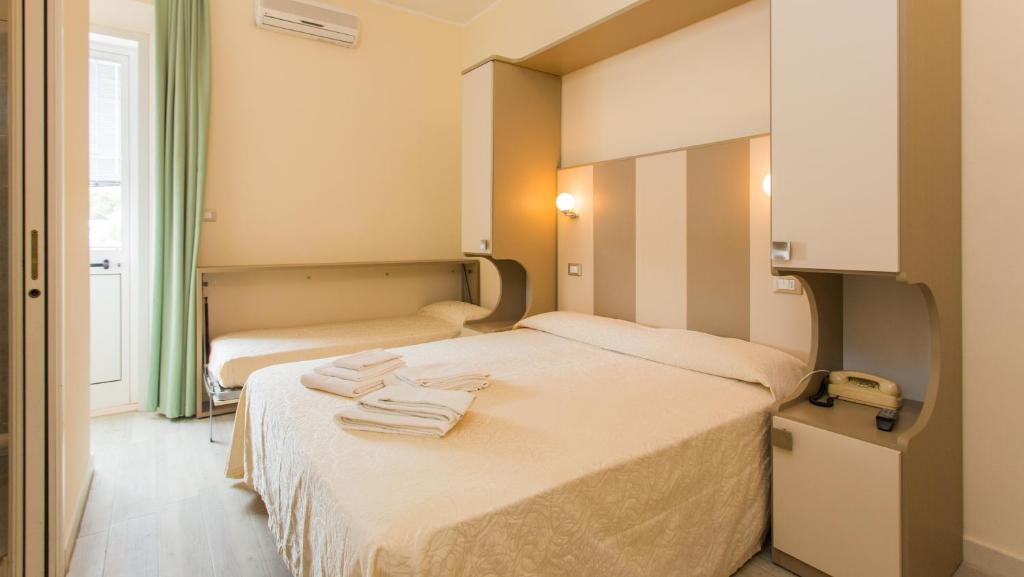 Postel nebo postele na pokoji v ubytování Hotel Trieste