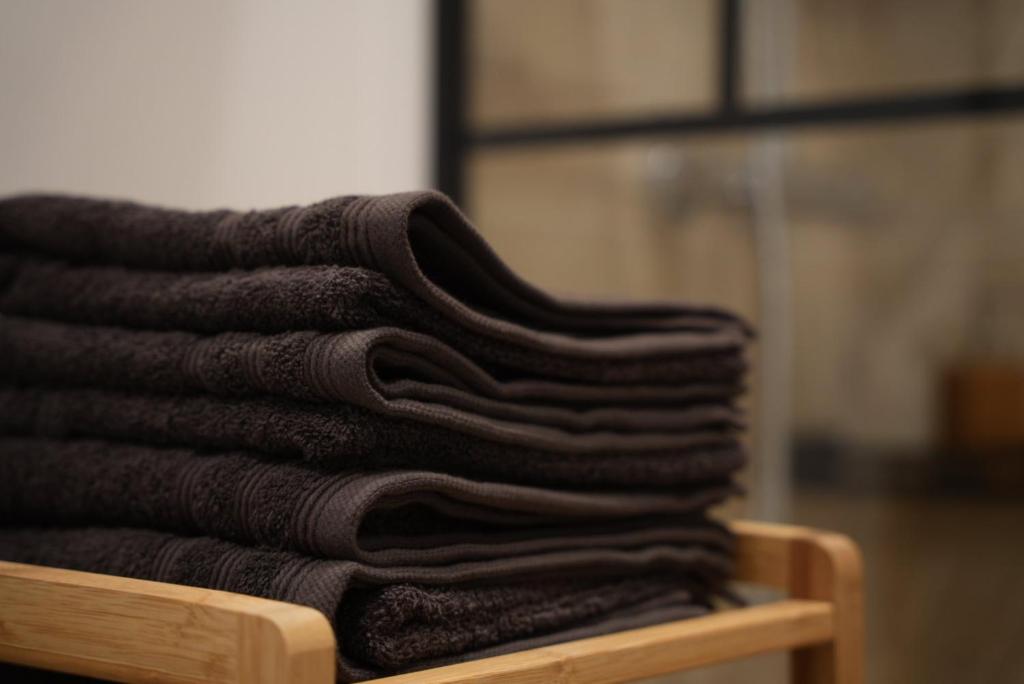 a stack of brown towels sitting on a table at « Le Madeleine » in Marseille