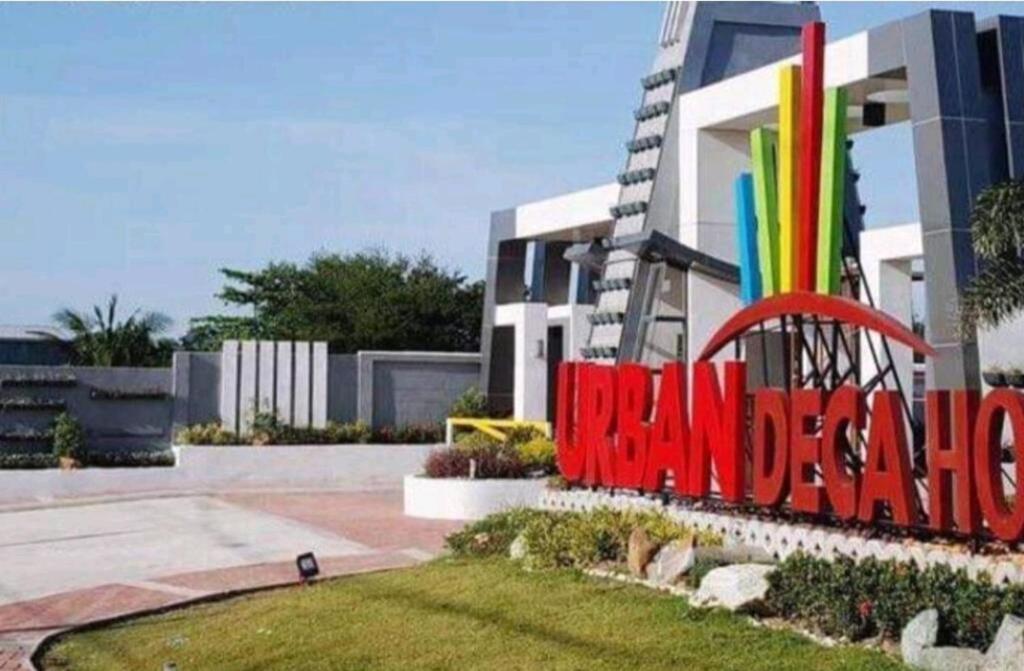 a building with a large sign in front of it at Drea Staycation 2 Bedroom at Urban Deca Homes Marilao in Marilao